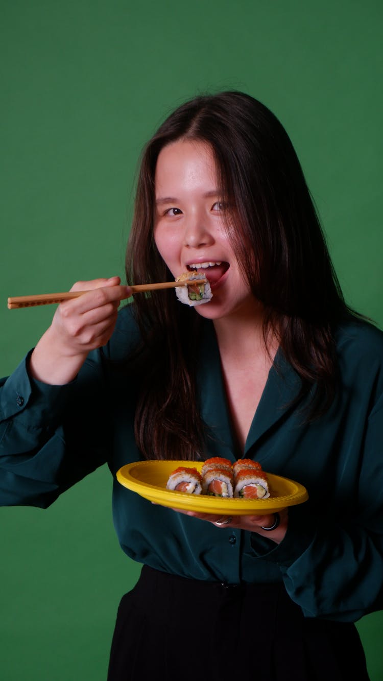 Woman Eating Sushi In Studio