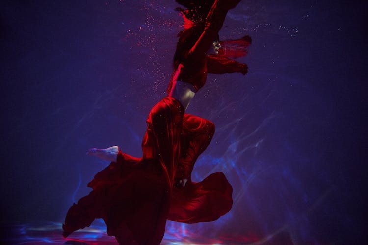 Underwater Shot Of Woman In Red Dress