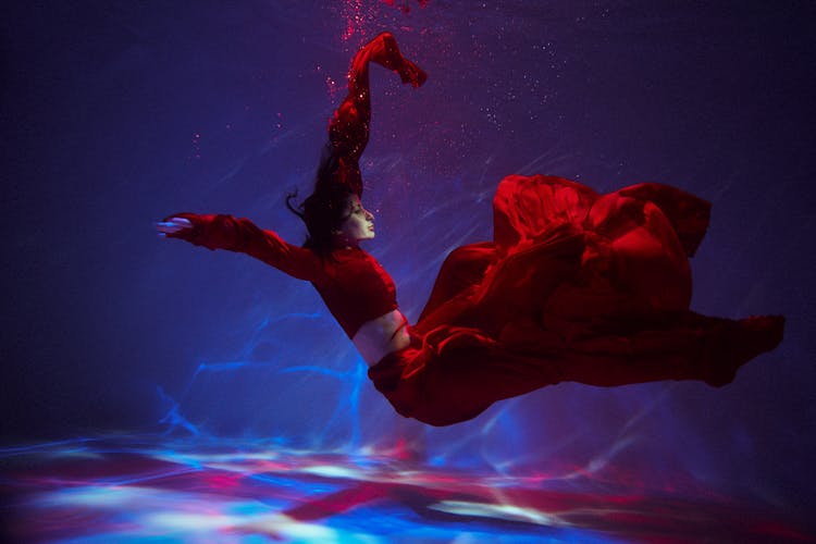 Woman In Long Red Dress Floating Underwater