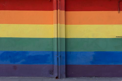 Free Vibrant rainbow wall with colorful pipes, representational of diversity in Rome. Stock Photo
