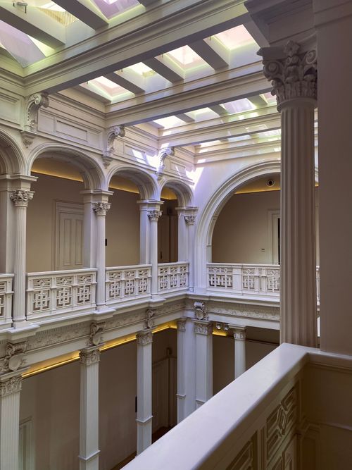 Free Classical architectural interior featuring columns, arches, and natural light through skylights. Stock Photo