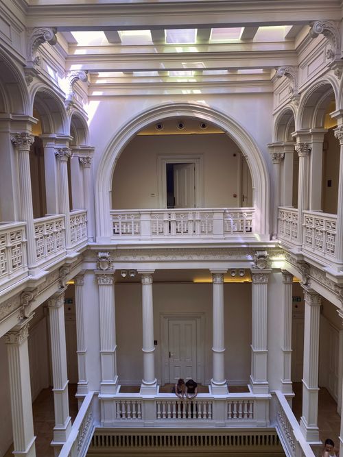 Free Elegant view of a neoclassical indoor courtyard with grand arches and columns. Stock Photo