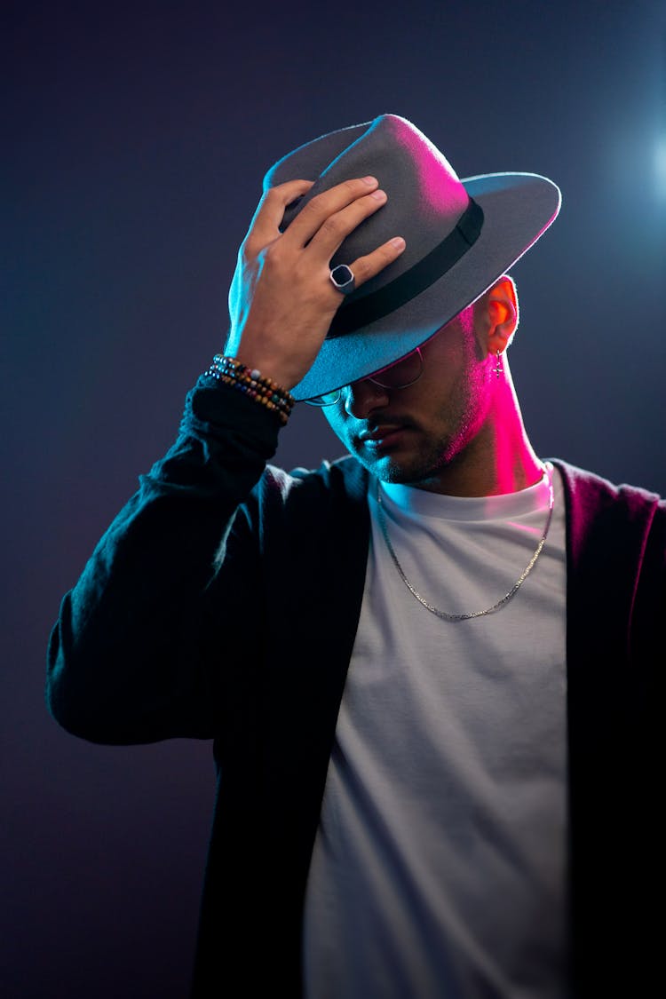 Portrait Of A Man Touching His Hat