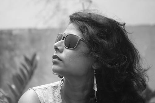 A Grayscale Photo of a Woman Wearing Sunglasses