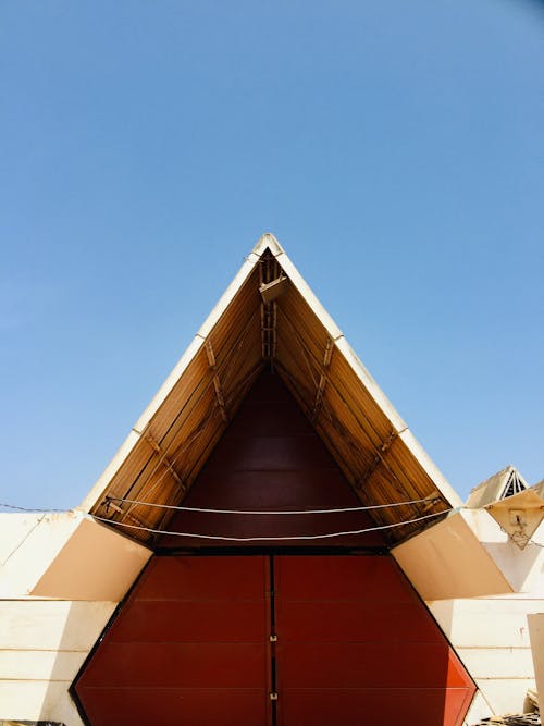 Facade of a Triangle Building under a Clear, Blue Sky 