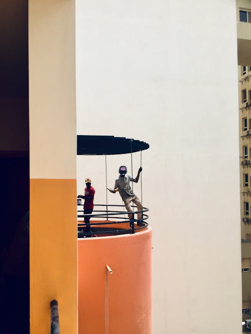 Men Painting the Facade of a High Rise Building 