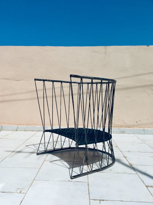 Modern Black Chair Standing on a Terrace in Sunlight 