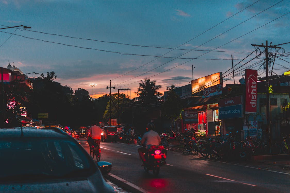 Person Riding Motorcycle on Road during Nighttime