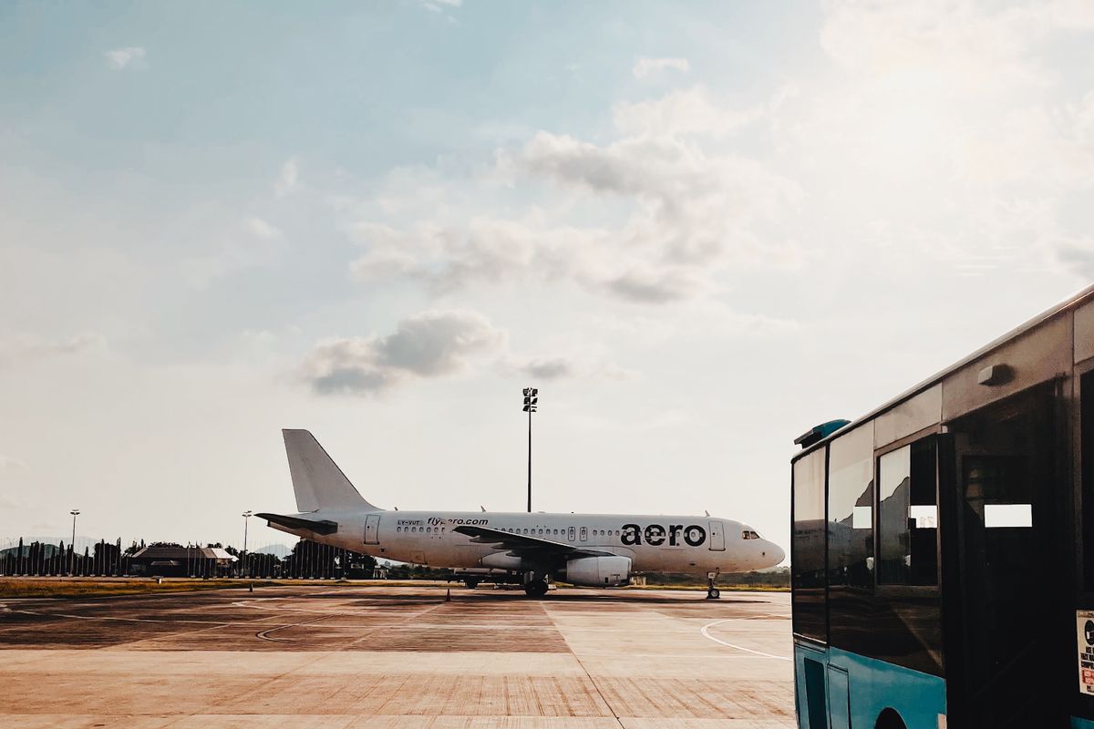 Aircraft parked on the apron next to an airport bus