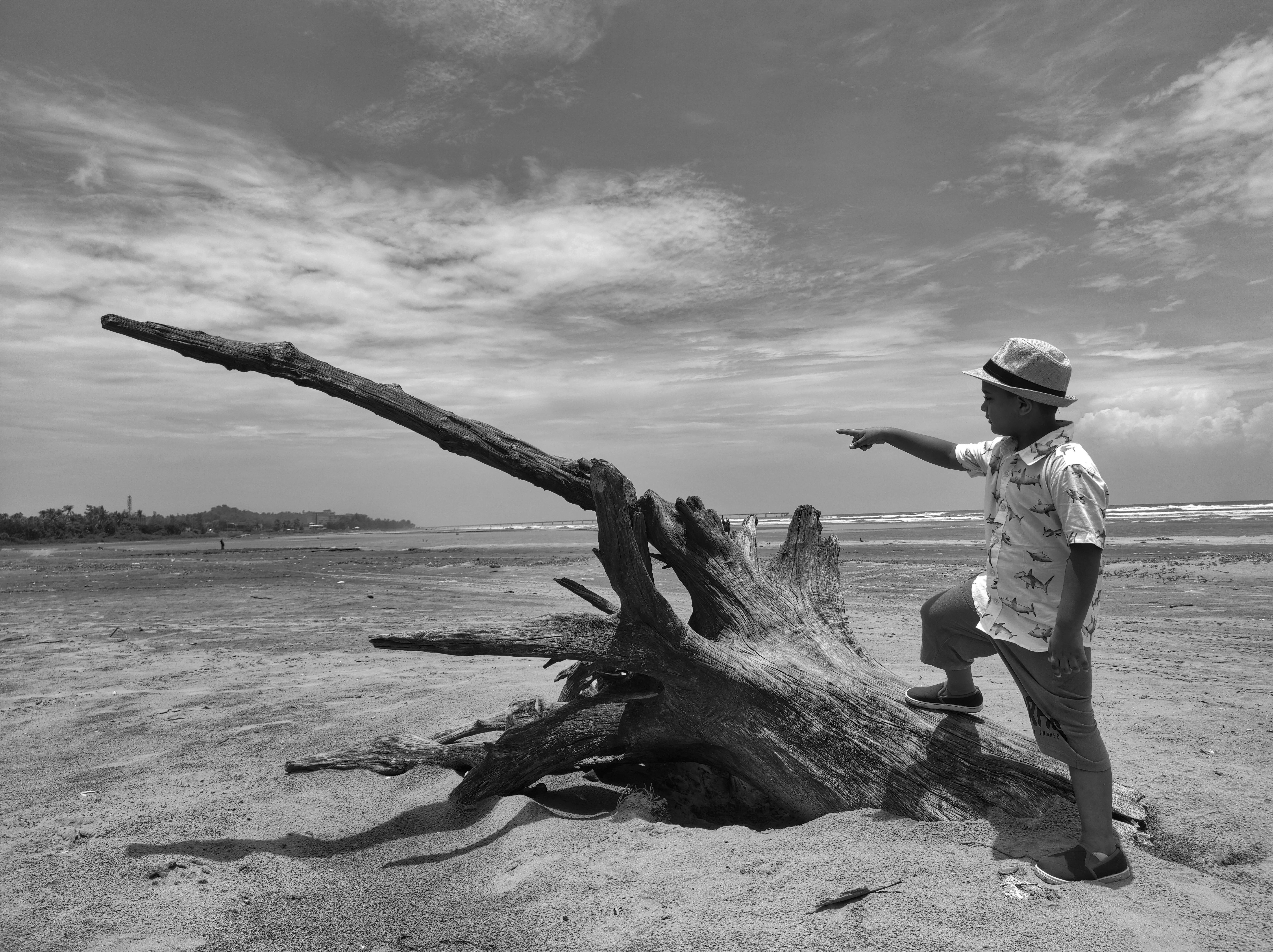 a boy standing on a beach