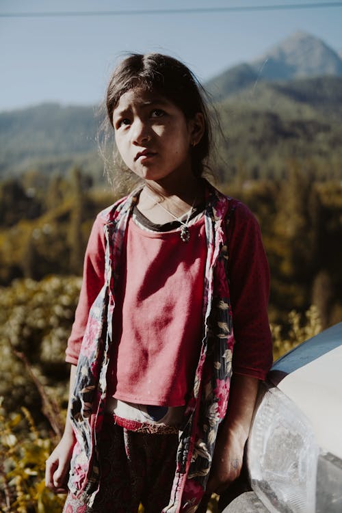 Portrait of a Girl with Worried Face in a Mountain Landscape