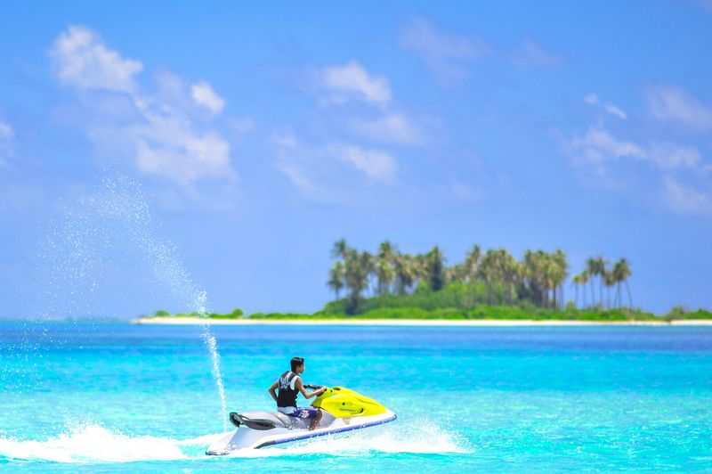 Jet ski adventure in vibrant tropical turquoise waters with palm trees
