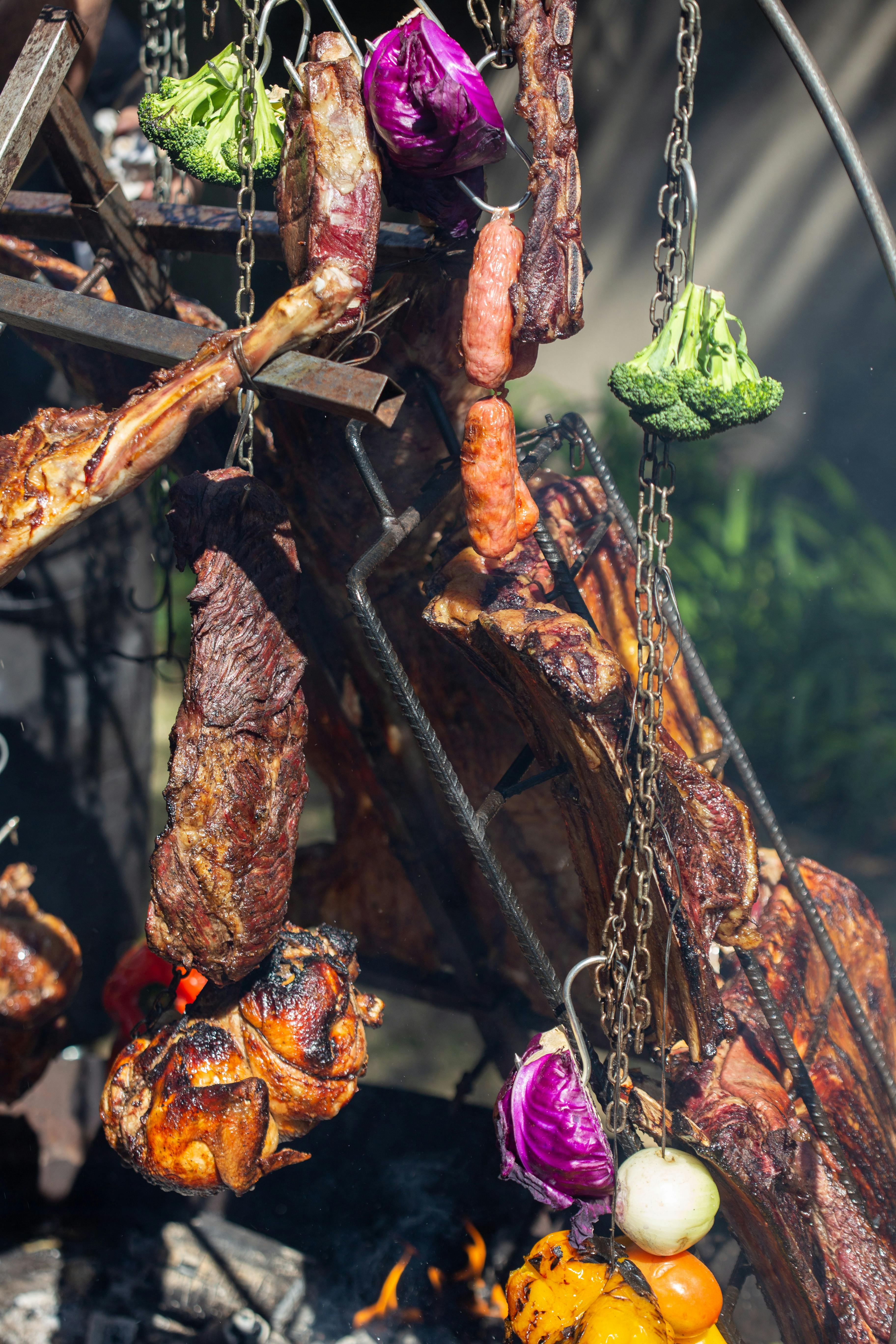 Various Fruits and Meats Hanging on Barbecue Chains · Free Stock Photo