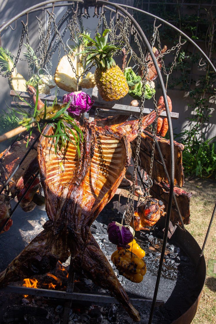 Meat And Fruit Installation Over A Grill