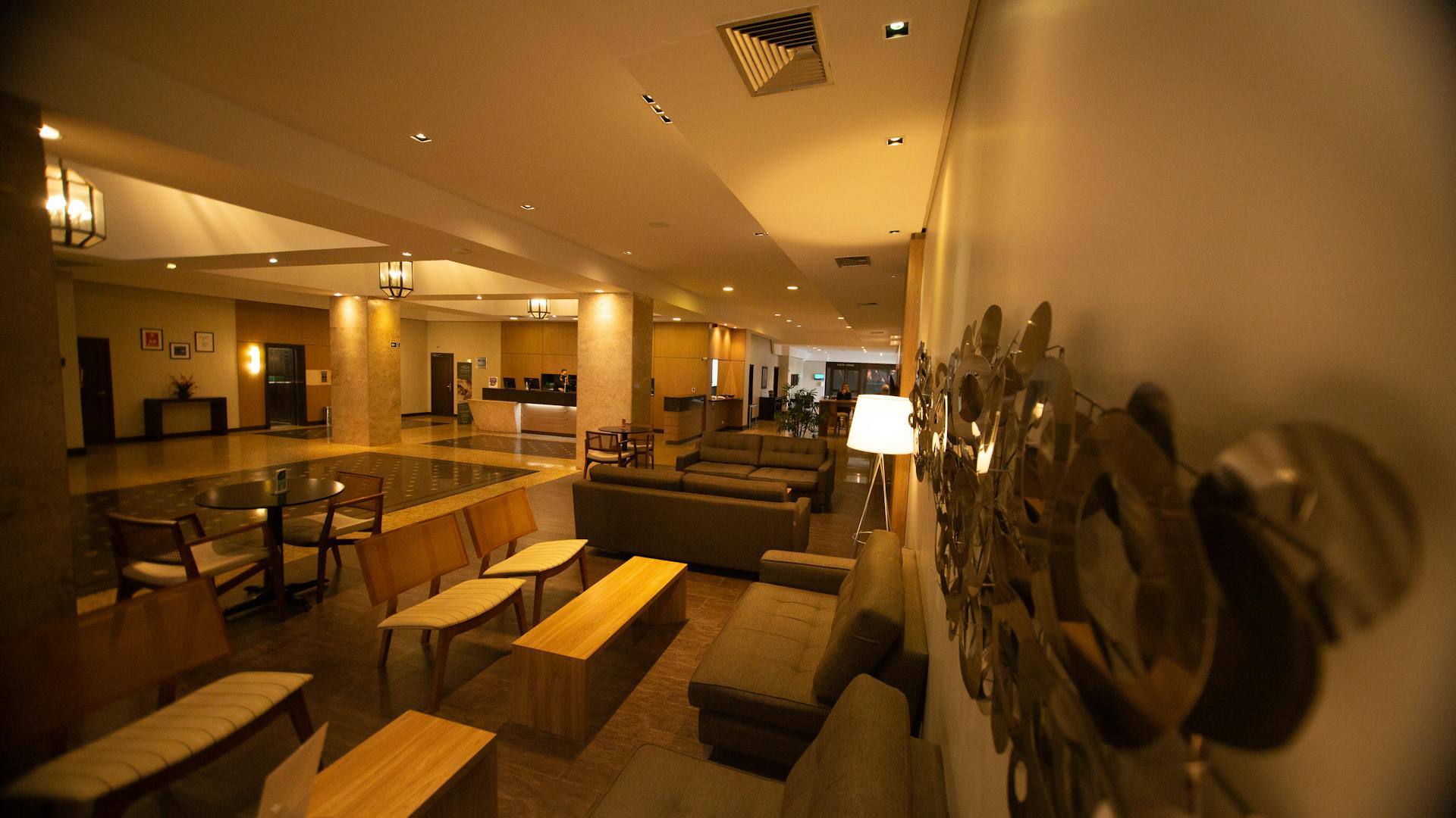 Spacious hotel lobby with modern seating and ambient lighting.