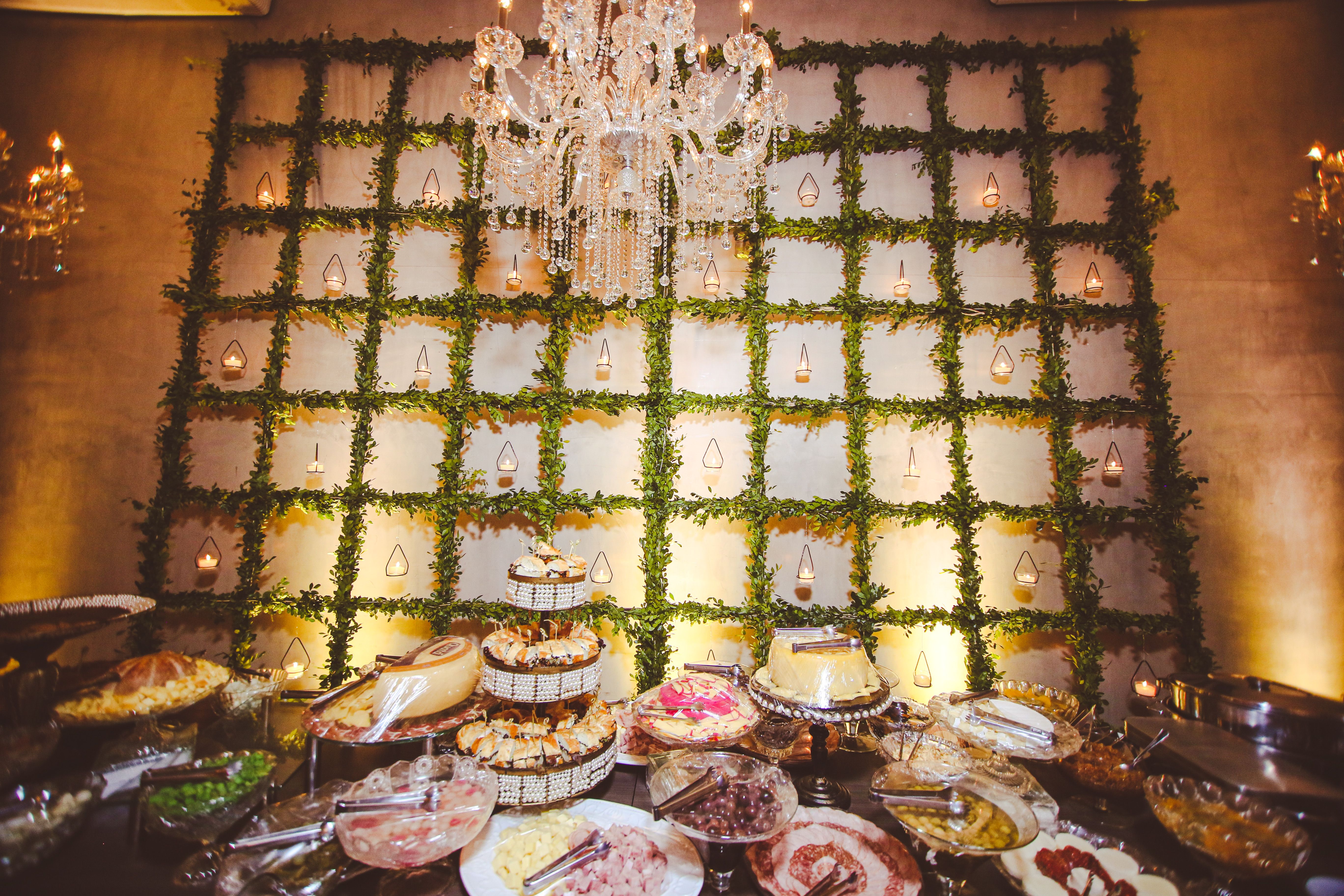 Luxurious buffet setting with a chandelier and elegant food display. Perfect for events and celebrations.