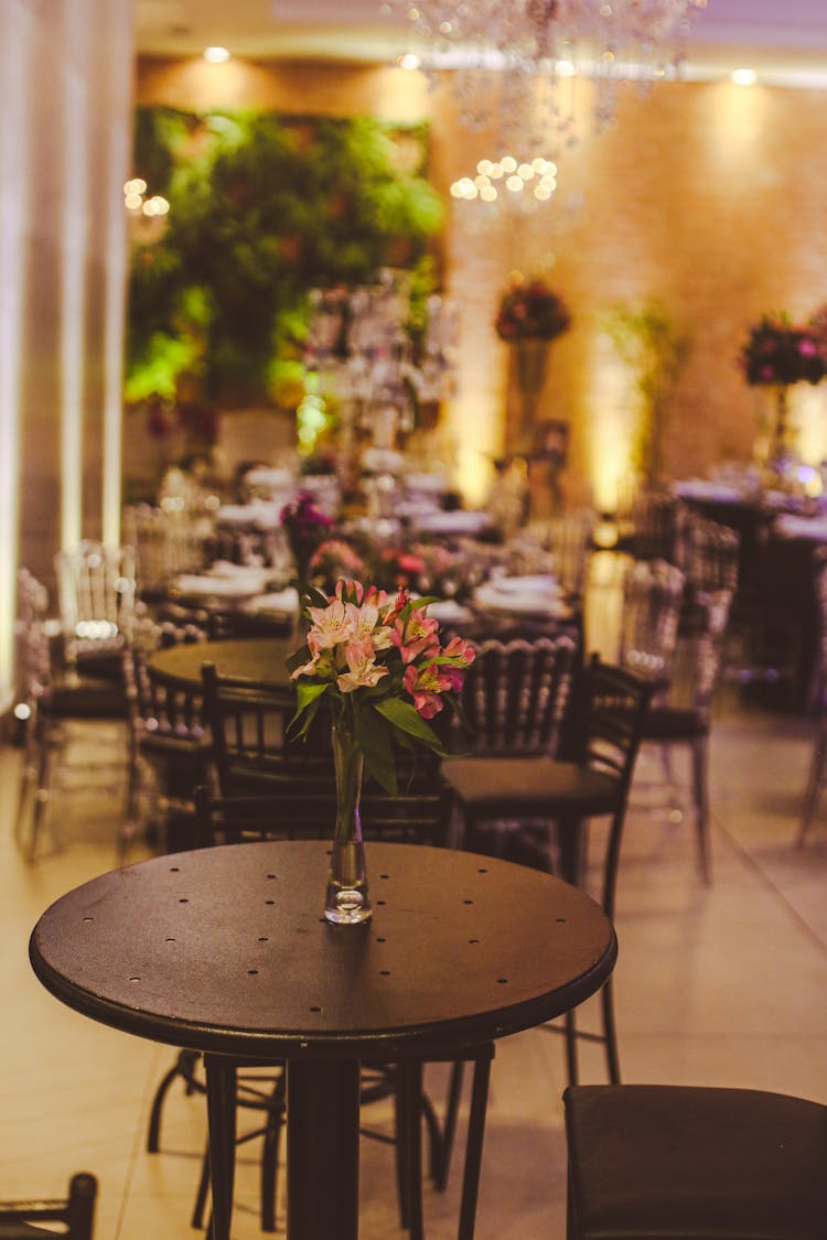 Vase With Flowers On Empty Cafe Table