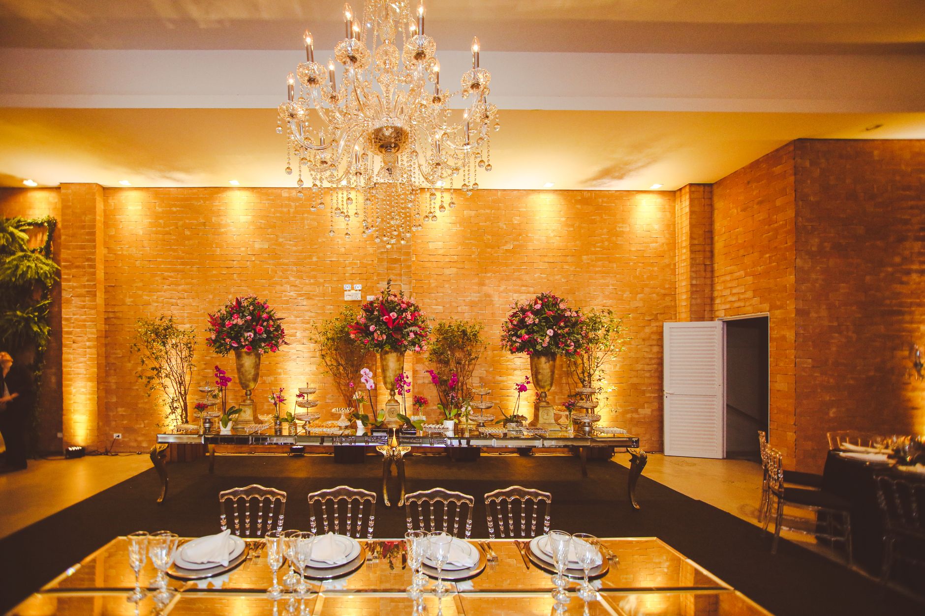 Luxurious reception hall decorated with flowers and a chandelier, perfect for events.