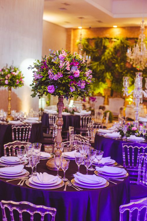 Free Luxurious wedding reception with floral centerpieces, elegant table settings in a beautifully decorated venue. Stock Photo