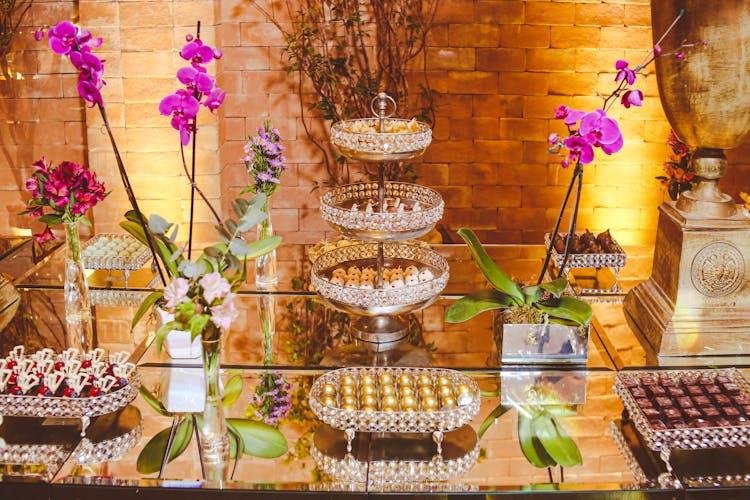 Chocolates And Potted Plants On Glass Shelves