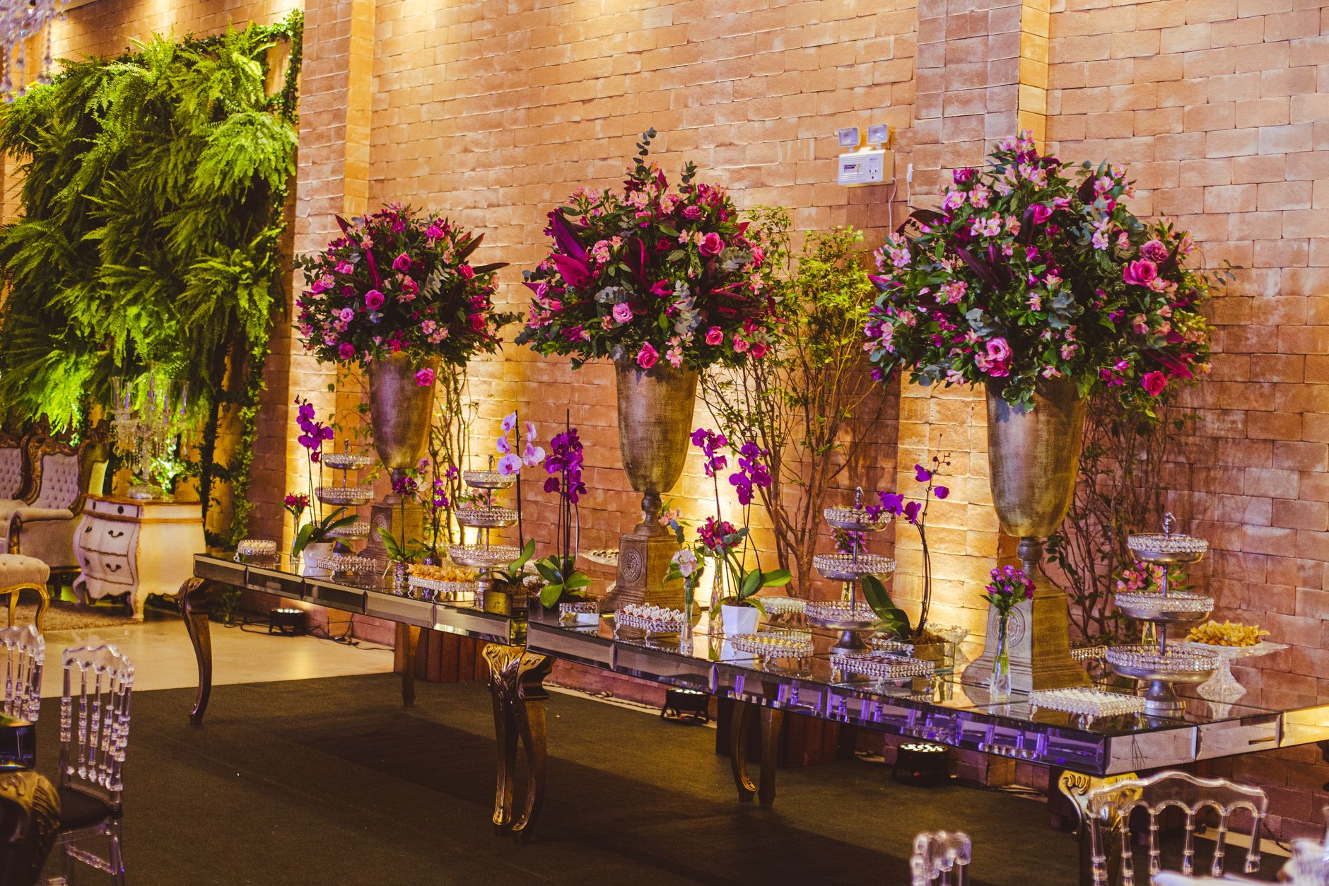 Luxurious event setup with vibrant floral arrangements and elegant table settings.