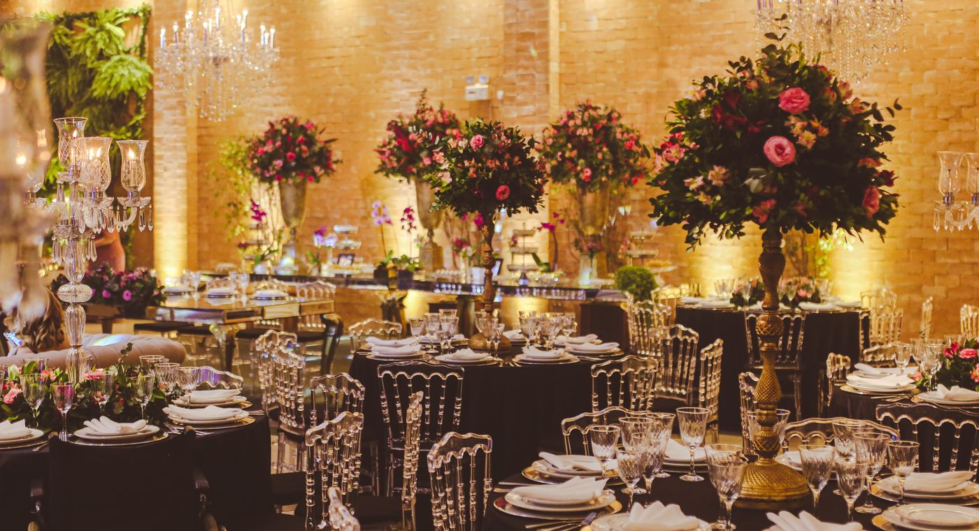 An elegant wedding reception venue set with floral arrangements and tables
