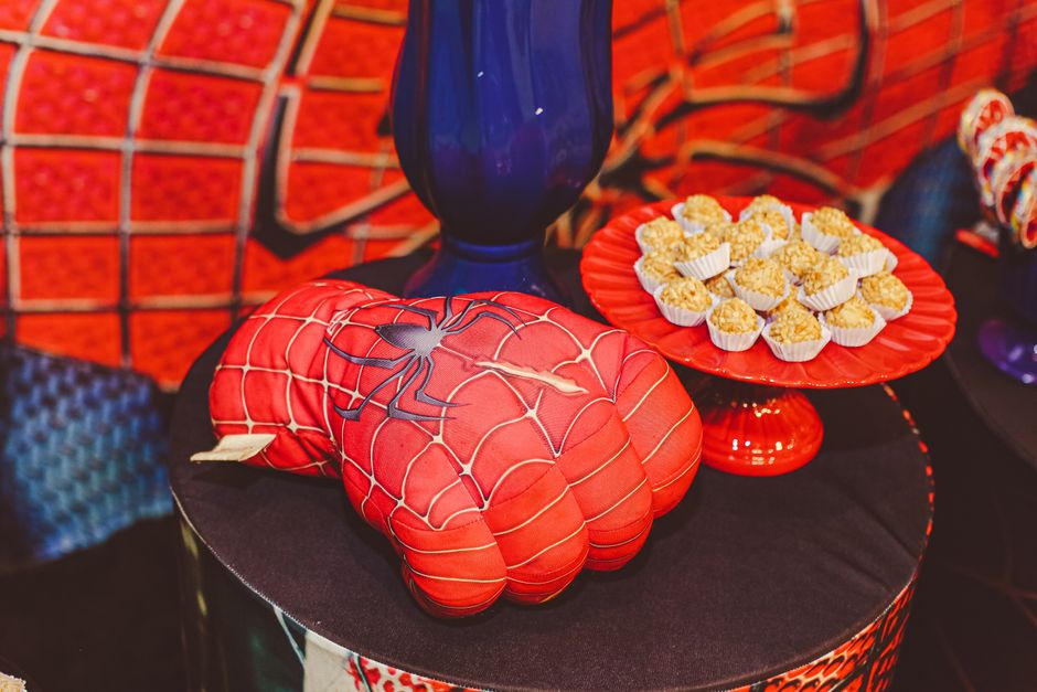 Vibrant Spider-Man themed glove and desserts on a decorative tray for a lively food presentation.
