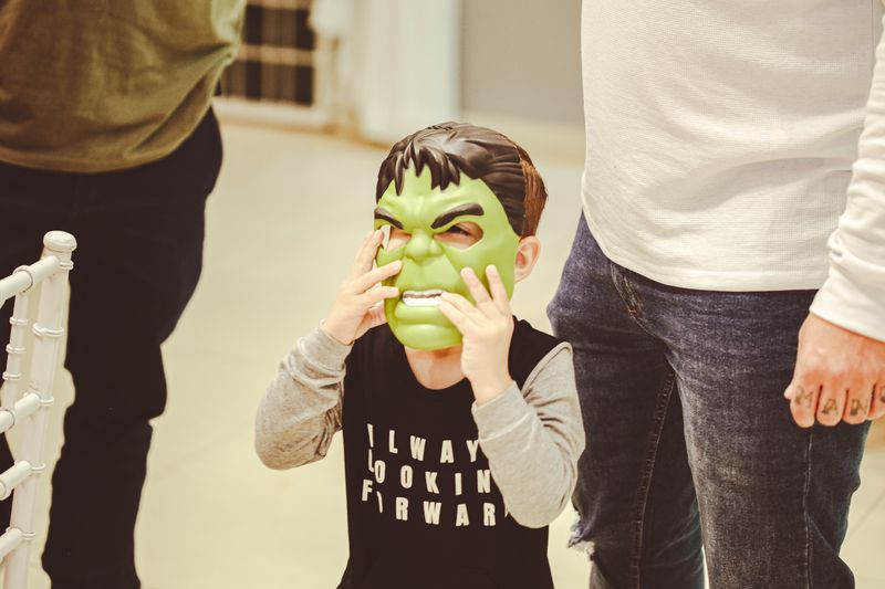 Kids wearing superhero masks at a party celebration