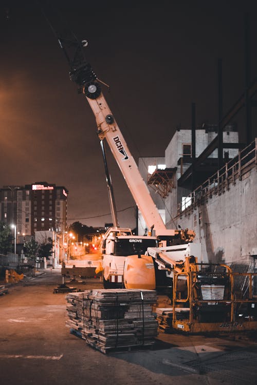 Cranes Working at Building Site at Night