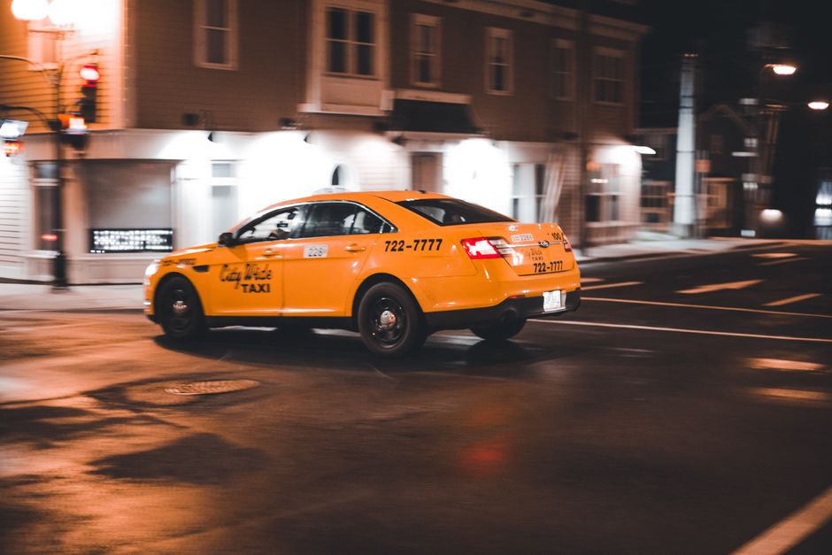 An official Parisian taxi waiting at a stand at night, representing safe late-night transport options in Paris.
