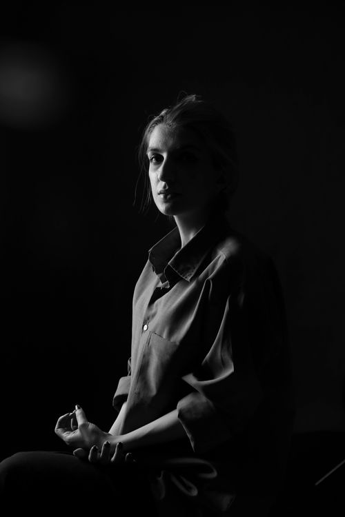 Free Black and white portrait of a pensive woman in a studio setting. Stock Photo