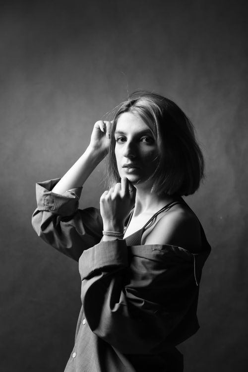Free Black and white portrait of a fashionable woman posing in a studio setting. Stock Photo