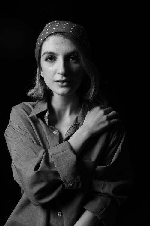 Free Elegant black and white portrait of a woman wearing a polka dot bandana, expressing calm. Stock Photo