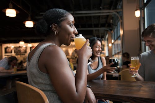 Person Drinking Beverage While Sitting Down