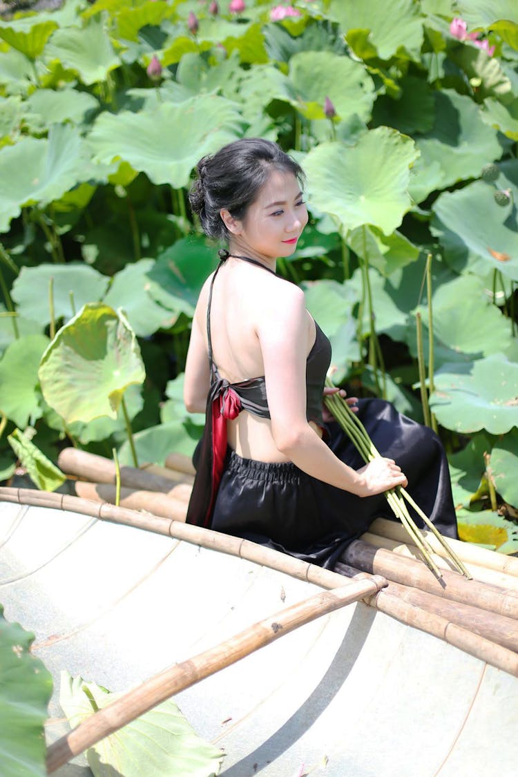 Woman Sitting In Boat In Lake