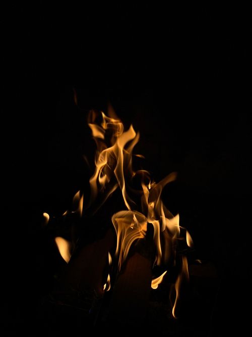 Free A mesmerizing close-up of flames dancing against a dark backdrop, creating a dramatic contrast. Stock Photo