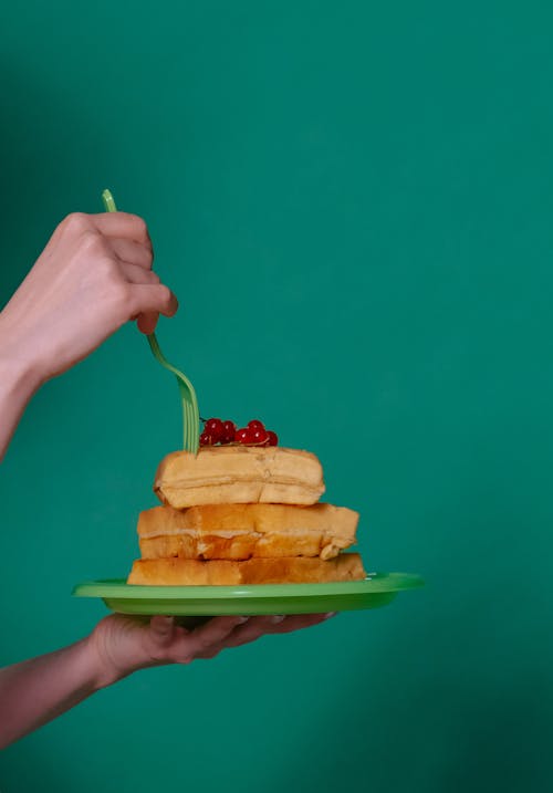 Free Woman Eating Fluffy Waffles with Fork Stock Photo