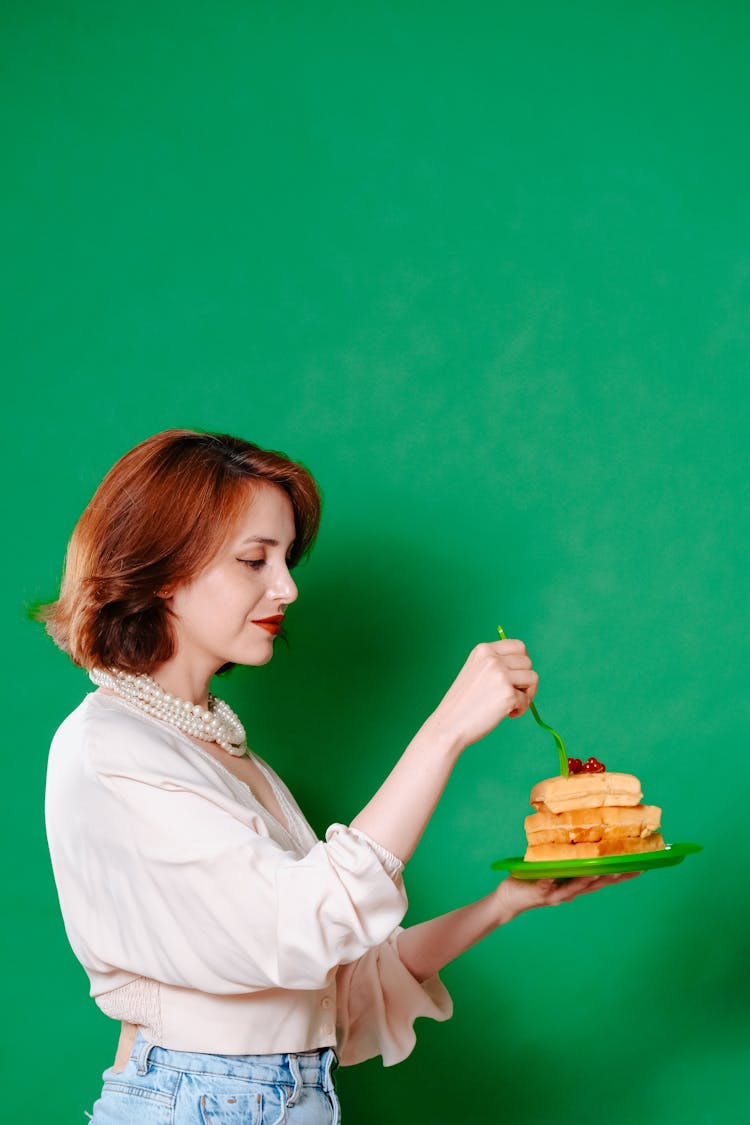 Woman Eating Cake Off A Plate