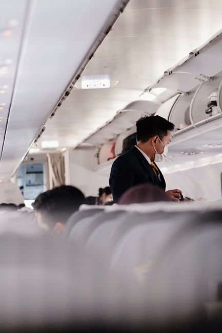 Modern airplane cabin with passengers using AI tools