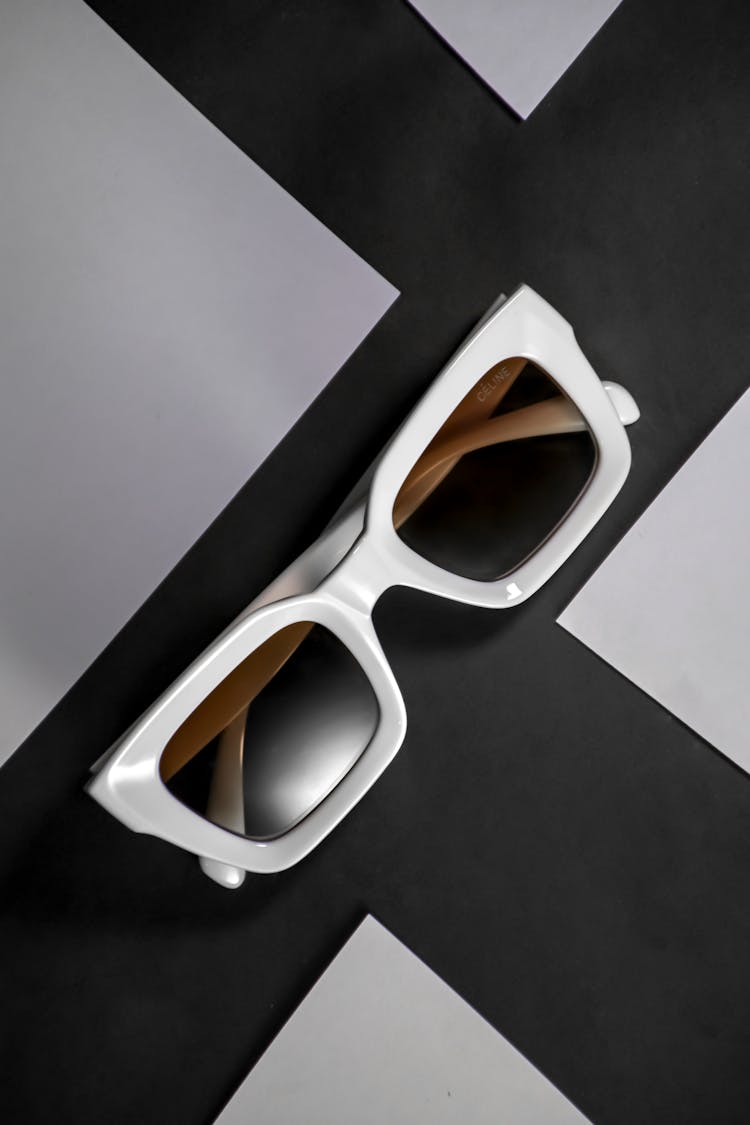 Black And White Sunglasses Against A Geometric Background