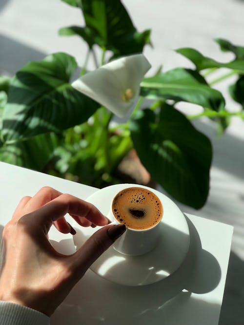 Person Holding White Ceramic Cup With Coffee