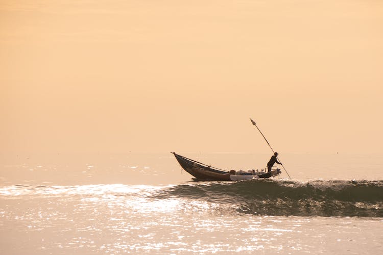 A Man Riding On Boat On Sea