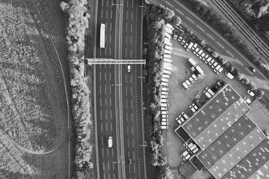Black and white aerial photograph of a highway next to a parking area in Luton, UK.
