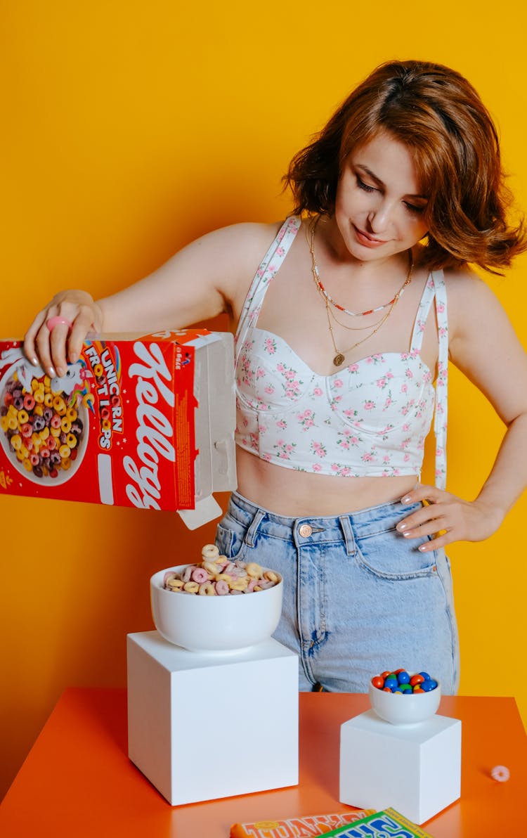 Woman In Floral Top Pouring Cereals