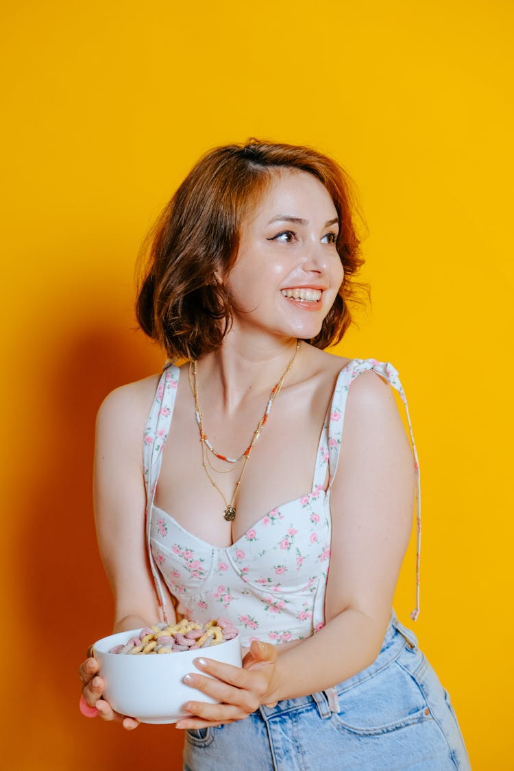 Smiling Woman Holding A Bowl Of Cereal