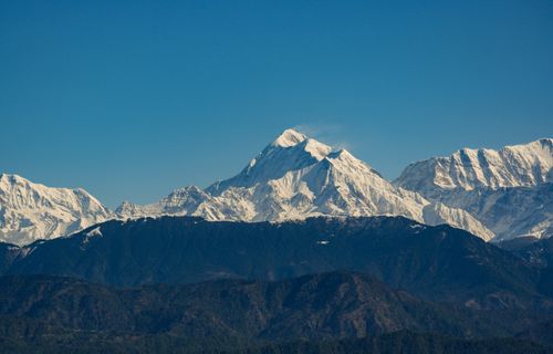 Free Breathtaking view of snow-capped Himalayan peaks under a clear blue sky. Stock Photo