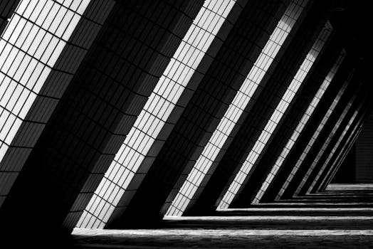 Dynamic black and white photo of modern architectural columns in Hong Kong.