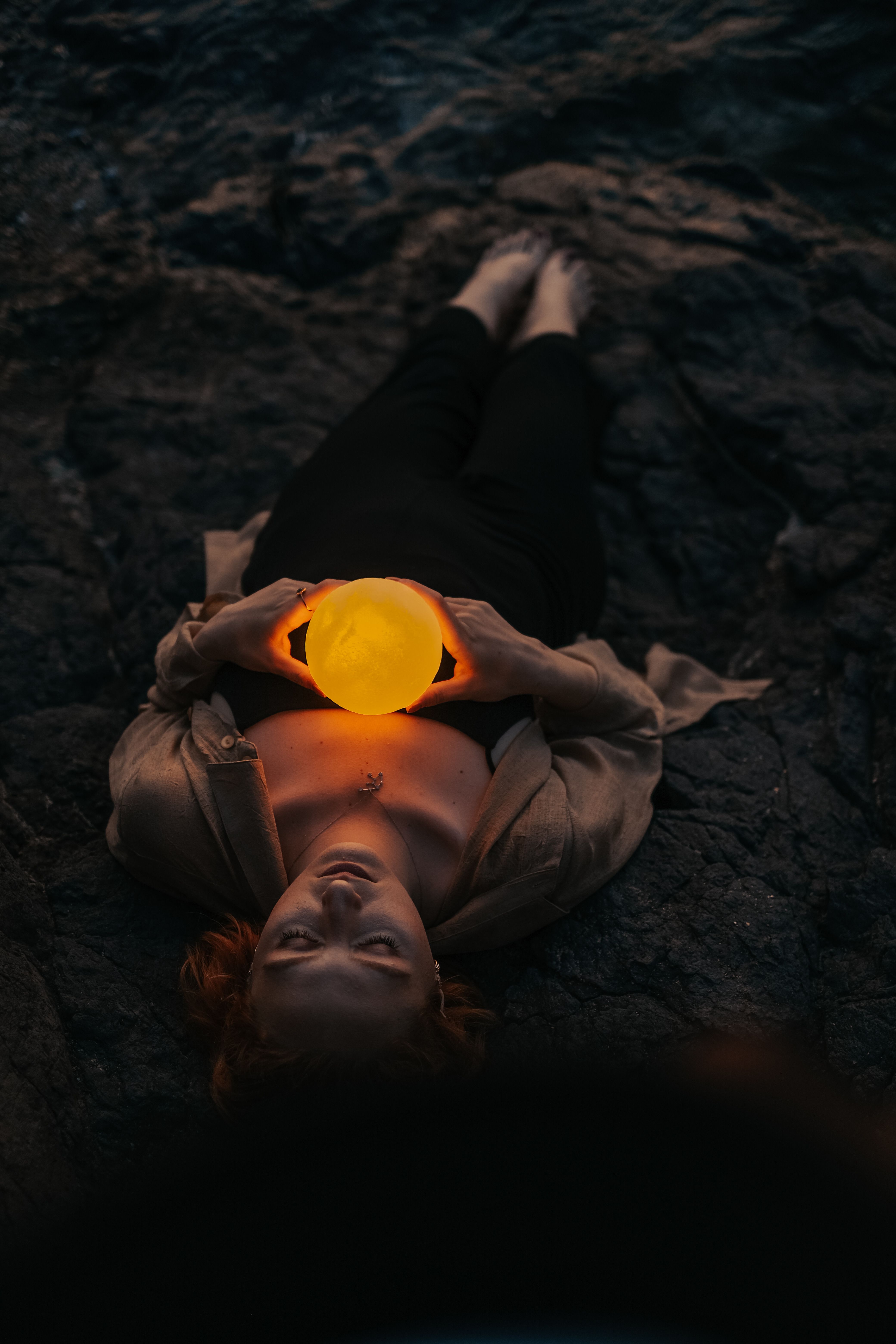 Woman Standing on a Rock Holding up a Glowing Orb · Free Stock Photo