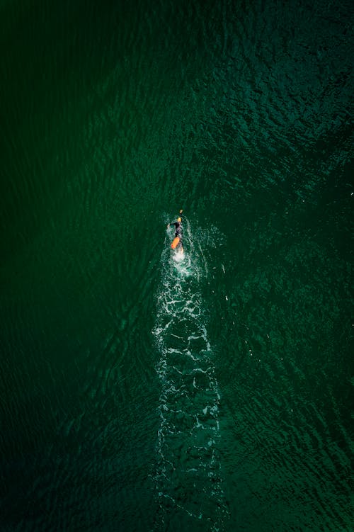 An Aerial Shot of a Person Swimming in the Ocean