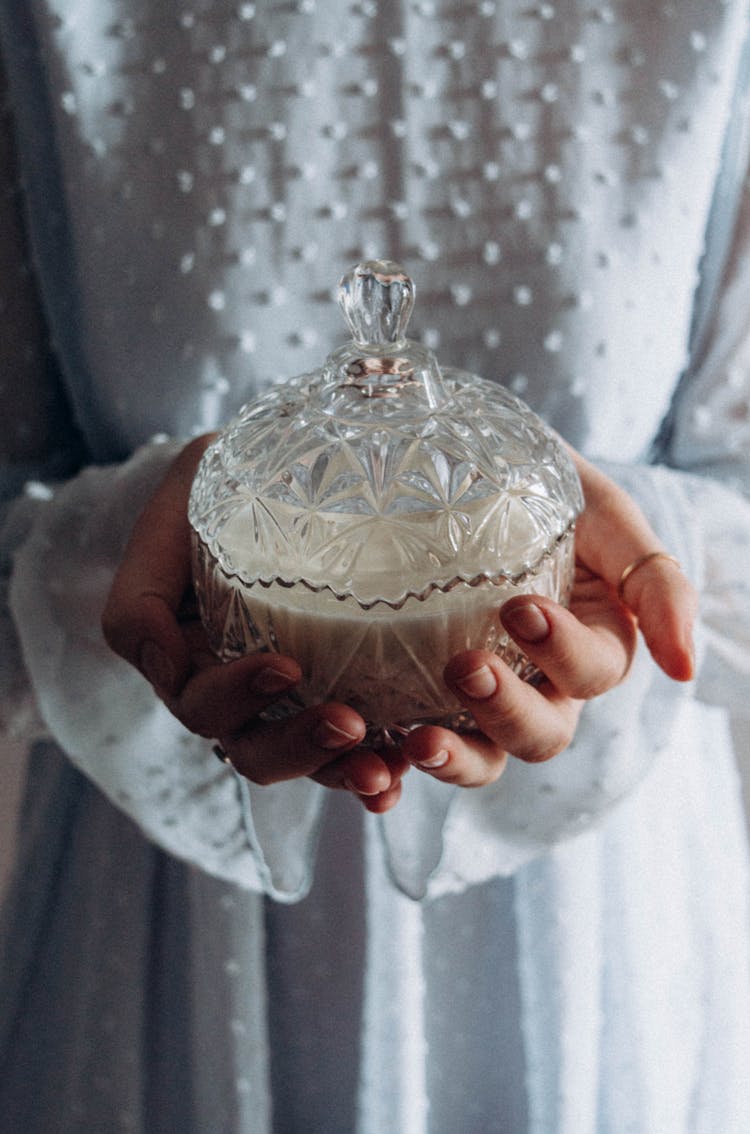 Woman Holding A Crystal Sugar Bowl In Her Hands